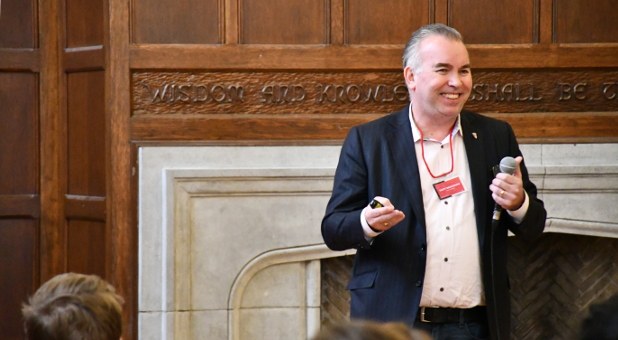 Scott Megginson addresses student with a microphone