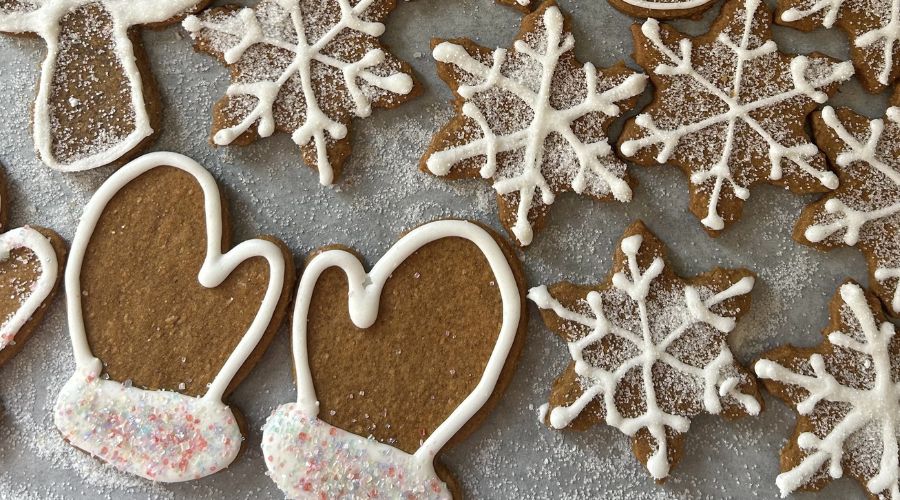 A plate of gingerbread cookies with white frosting and snowflake designs, representing Vanaema’s Estonian recipe.