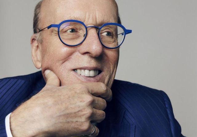 Stephen Smith, wearing glasses and a blue suit, marks ten years since his historic $50-million donation to Smith School of Business.