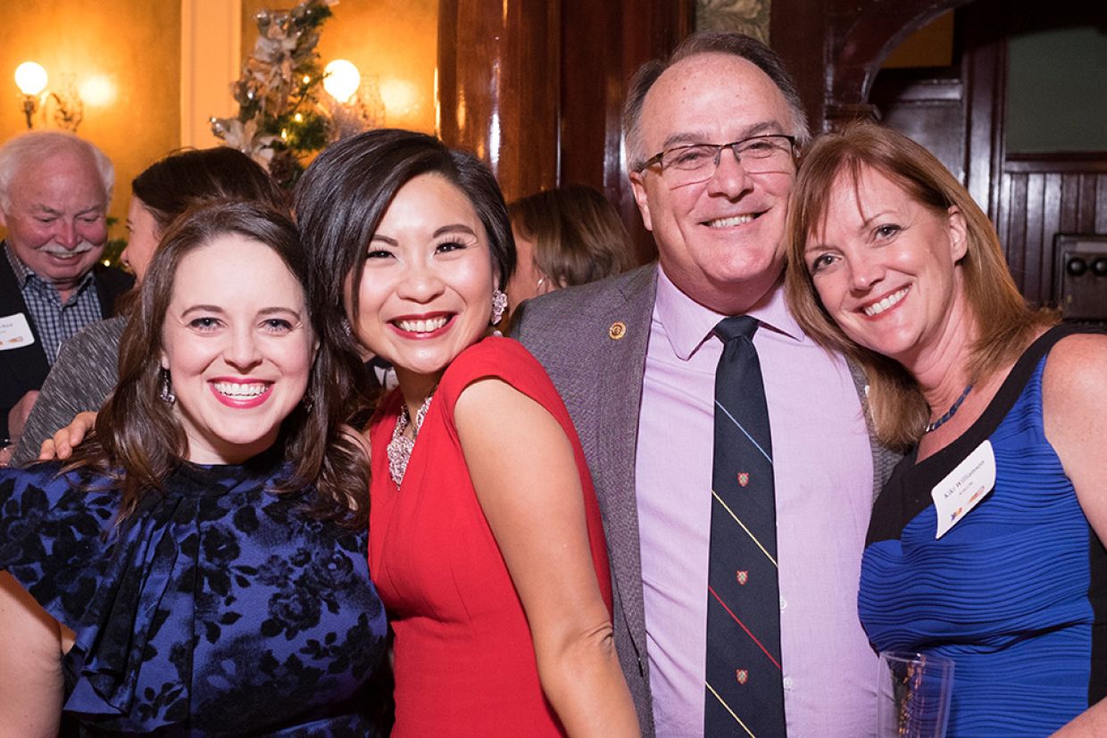 A group of alumni at the annual wine and cheese