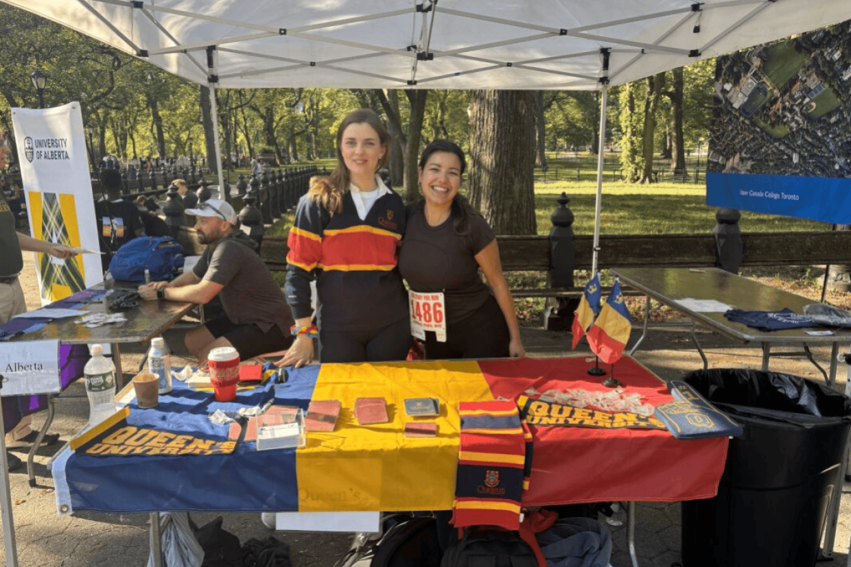 Alumni posing at the Queen's table at the Terry Fox Run in Central Park.