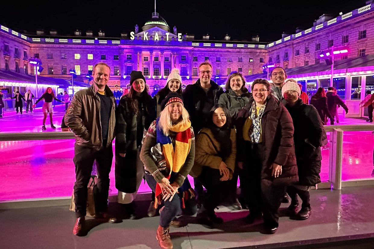 Smiling Queen's Alumni at the ice-skating plaza in UK  