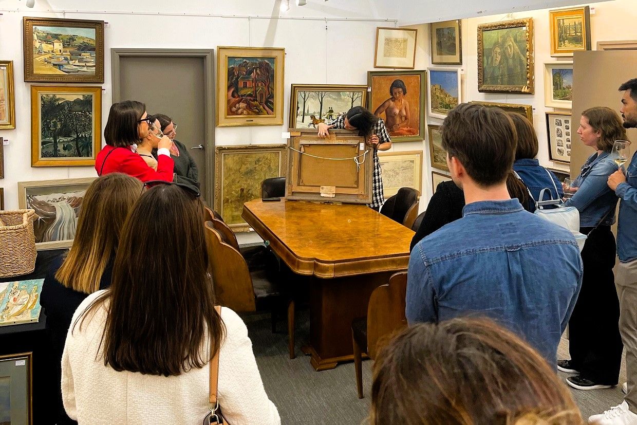 Alumni in the UK at the Roseberys Fine Art Auctioneers staring at the art