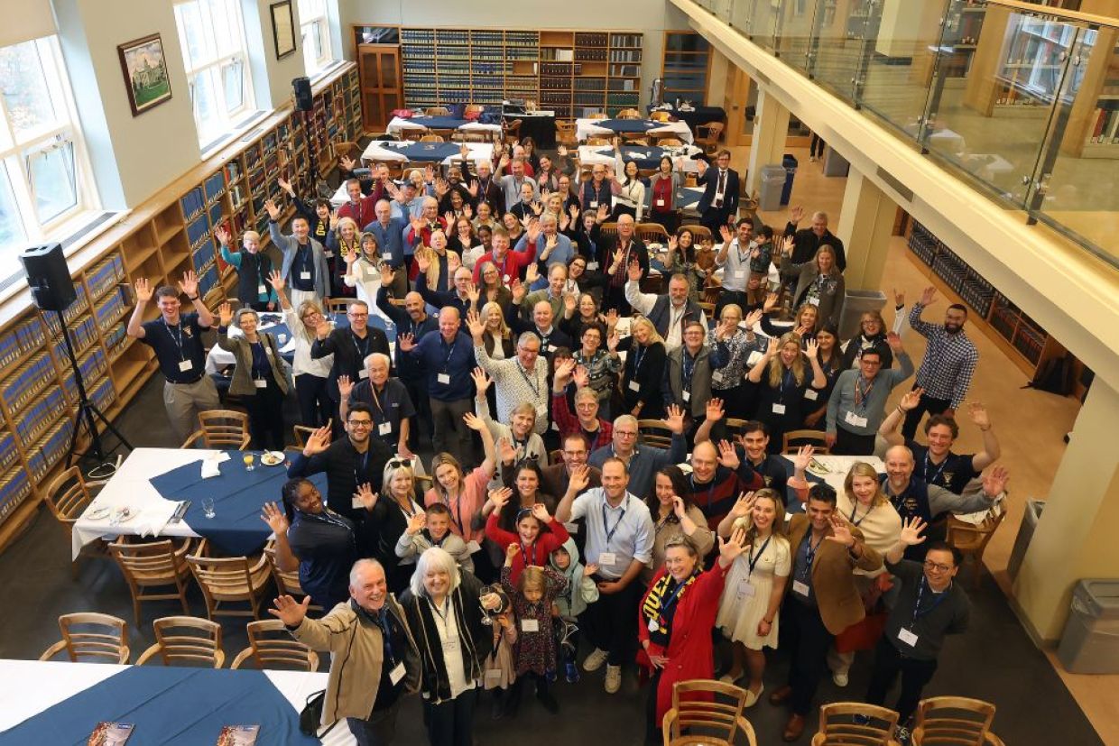 aerial shot of law alumni pose in the law library 