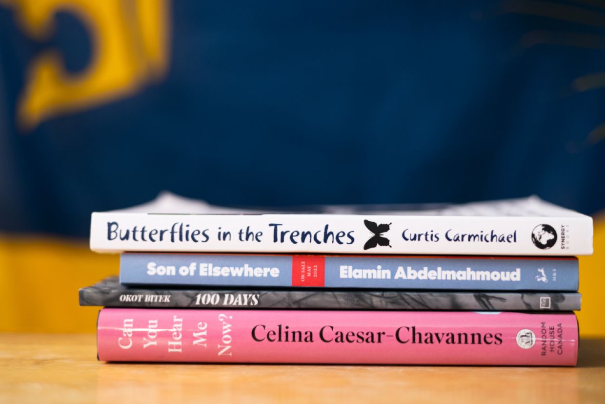 Four books are stacked horizontally. 