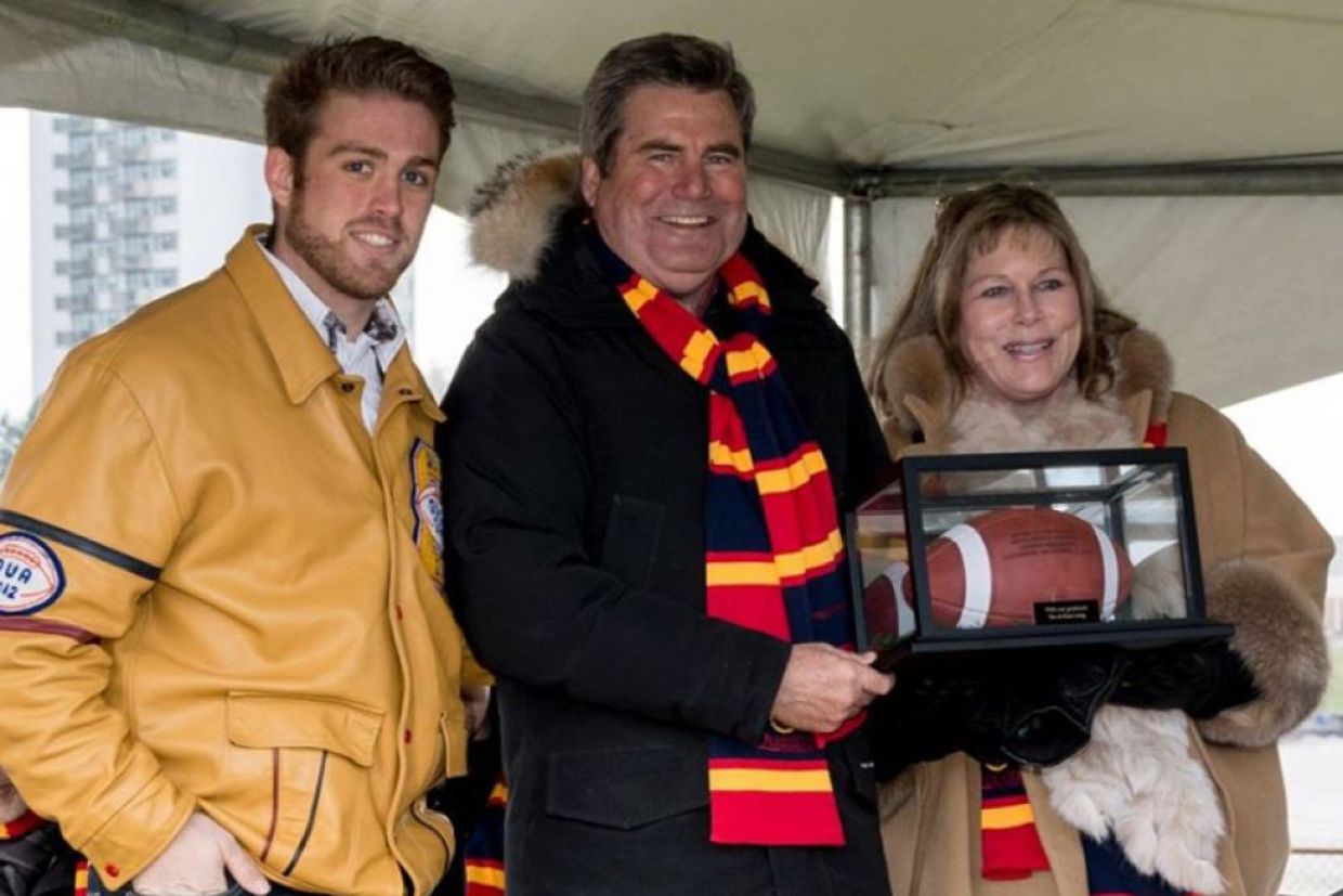 Stu Lang and Kim Lang holding a football