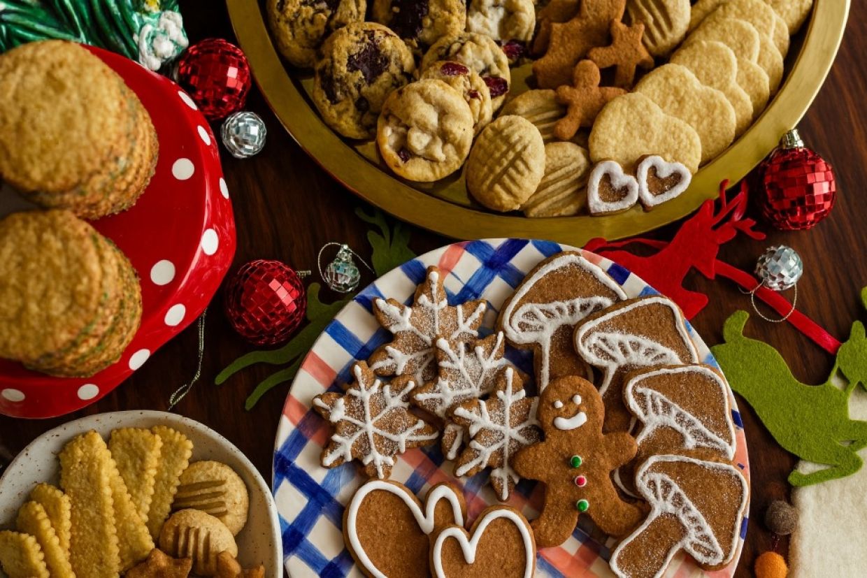 A table filled with an assortment of various cookies, showcasing different shapes, colors, and textures.
