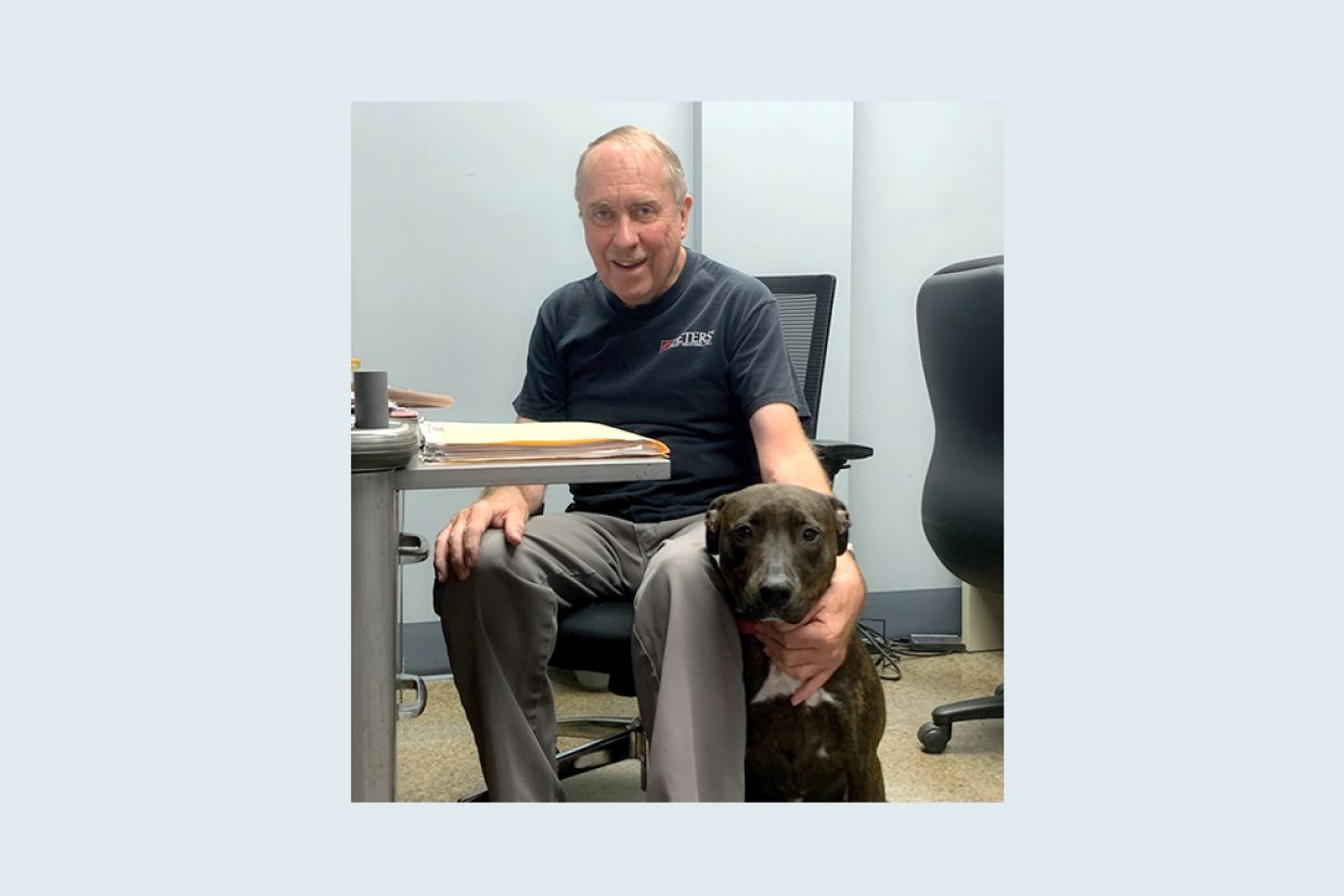 Joseph Huff sits in his office at Peters’ Heat Treating with his dog Rosie, known as the “Corporate Watchdog.”