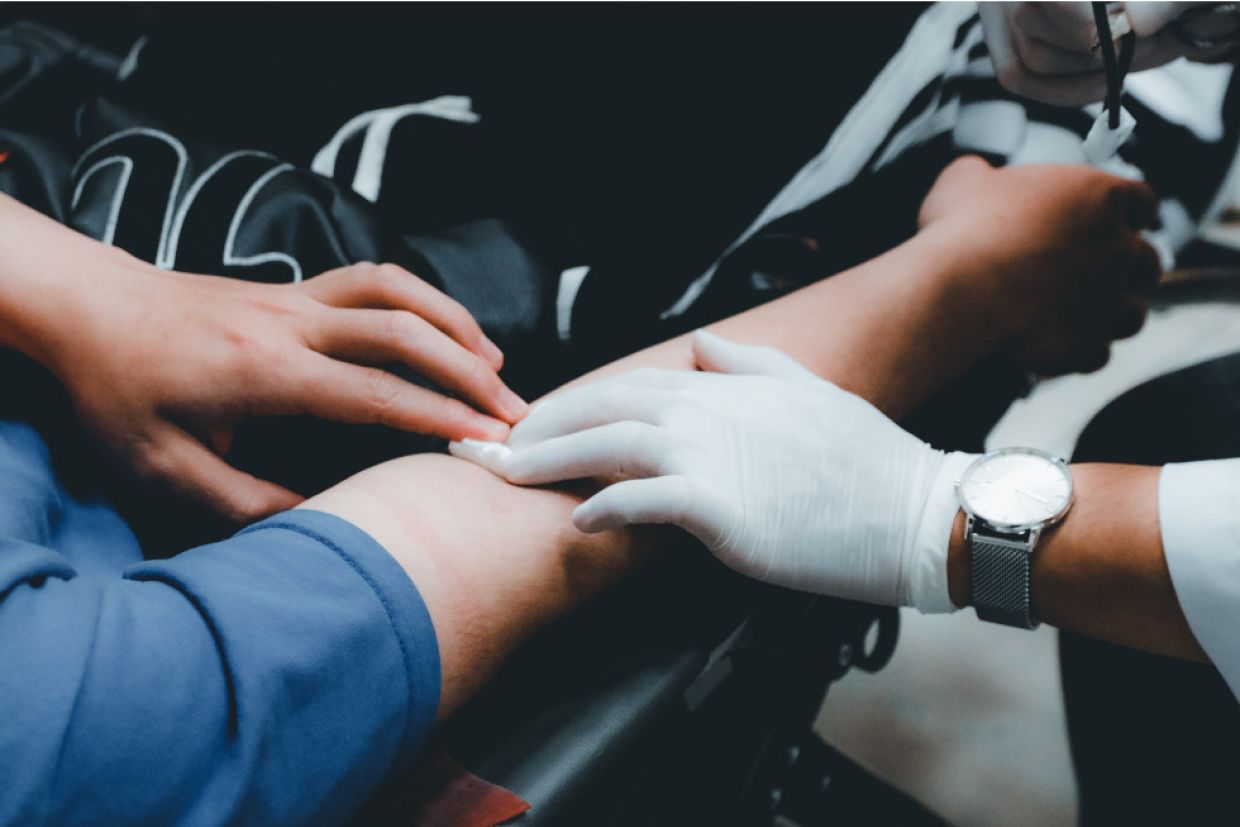 a health professional assists with a blood donation