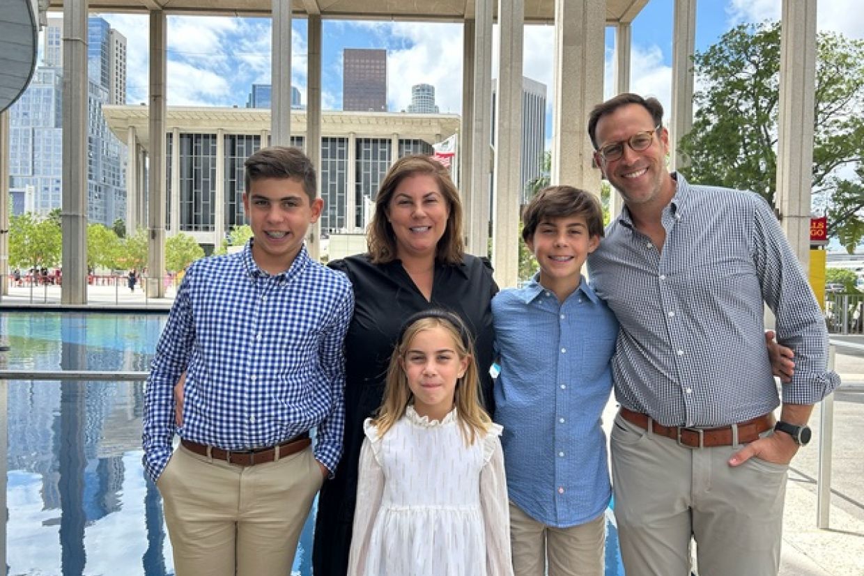 Stephen Sachs, his wife Kate, and their three children stand outside their home.