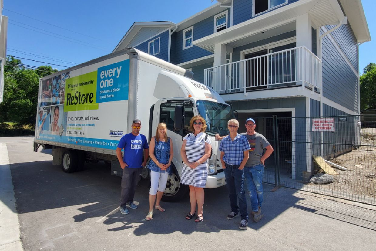Habitat for Humanity Canada CEO Julia Deans in front of a home.