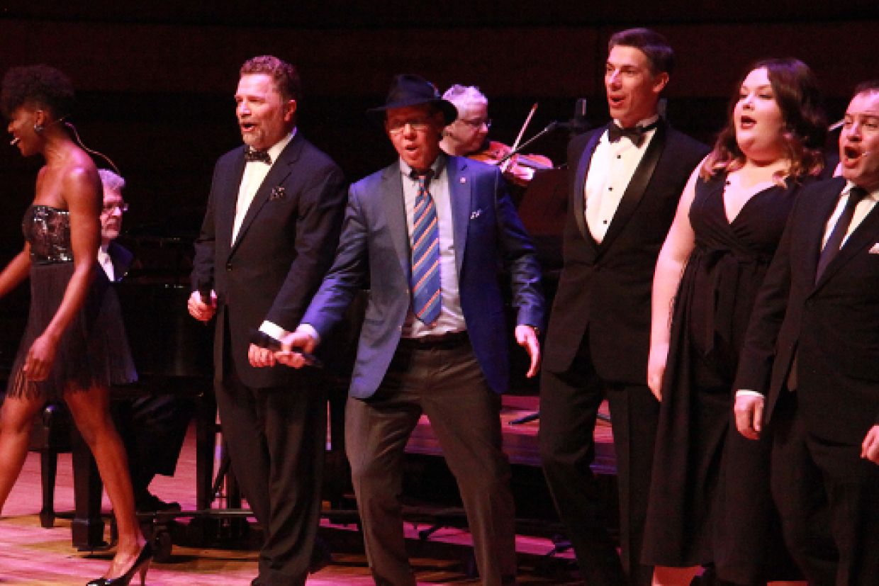 Aubrey Dan and Craig Walker perform at centre stage alongside Queen's drama and music students and alumni.