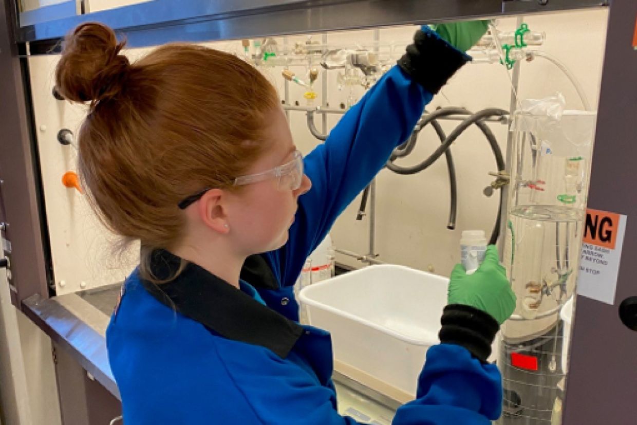 Department of Chemistry graduate student Hailey Poole takes samples from a prototype batch of sanitizer.