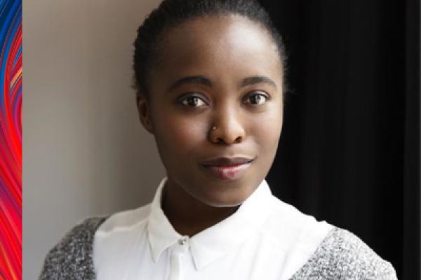 photo of Daria looking at the camera wearing a white collared shirt and grey sweater 