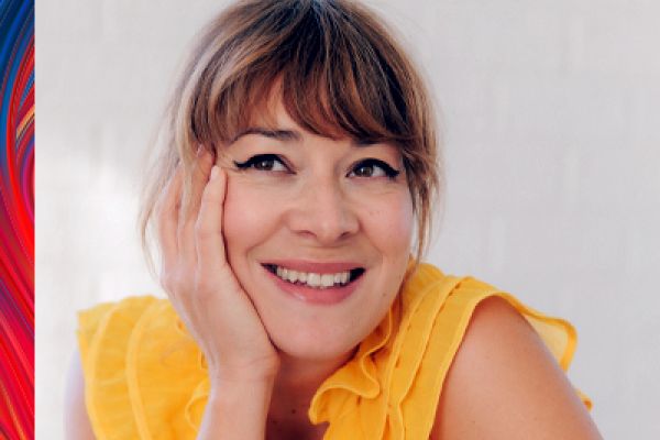photo of Jill Barber looking at the camera smiling, wearing a yellow shirt. 