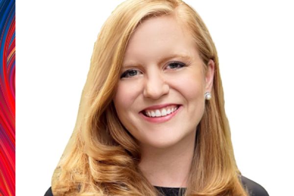 photo of Kristine Robinson looking at the camera, smiling. Kristine is wearing a black shirt