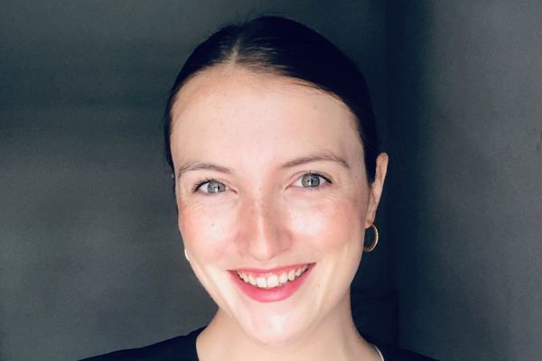 Megan Pfiffer smiling from the shoulders up, wearing a white shirt and black jacket 