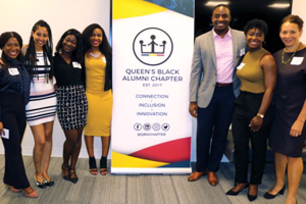 Members of QBAC with QBAC banner.