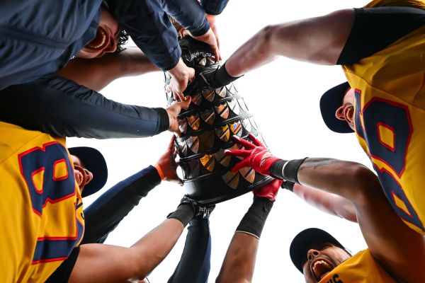 Football players holding the cup as a victory sign. 