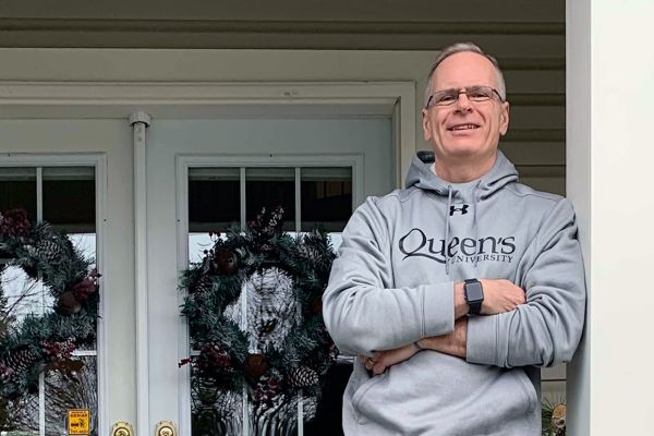 Doug Bruce standing on a porch.