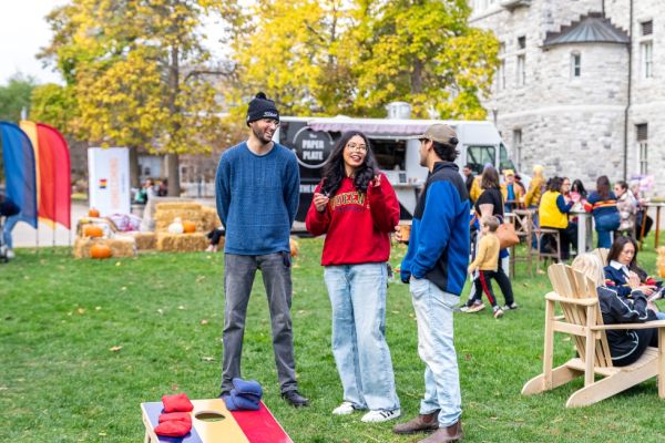 Alumni play lawn games at fall harvest gathering