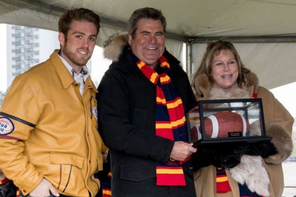 Stu Lang and Kim Lang holding a football