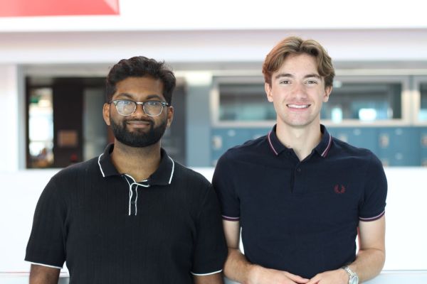 Qlean co-captains Ahnaaf Khan and Jacob Rivelis smiling wearing black polo t-shits. 