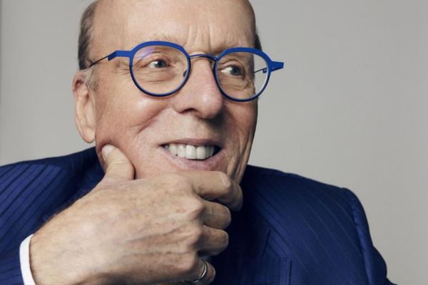 Stephen Smith, wearing glasses and a blue suit, marks ten years since his historic $50-million donation to Smith School of Business.