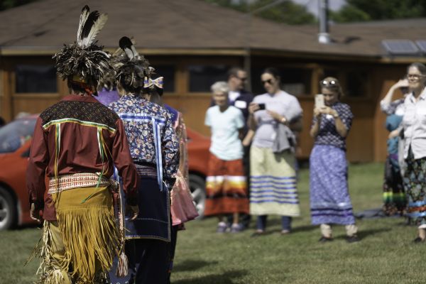 Alumni watch members of the Six Nations of the Grand River walk during an outdoor event on September 13 2022