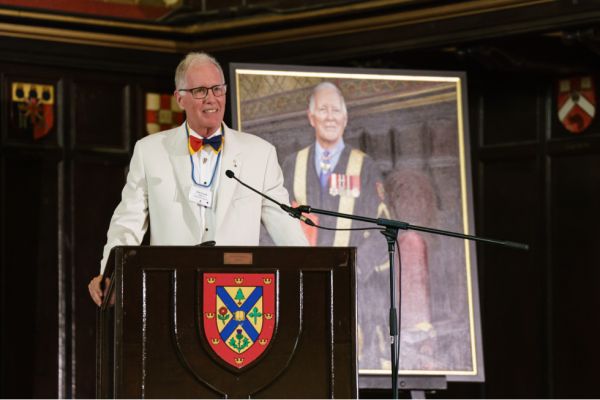 Chancellor Emeritus Jim Leech, MBA’73, stands in front of his official portrait during his farewell celebration in Grant Hall on June 24.