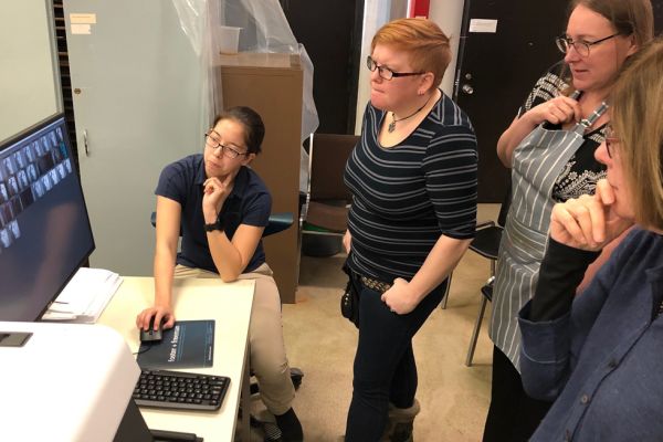 Students gathered around a computer