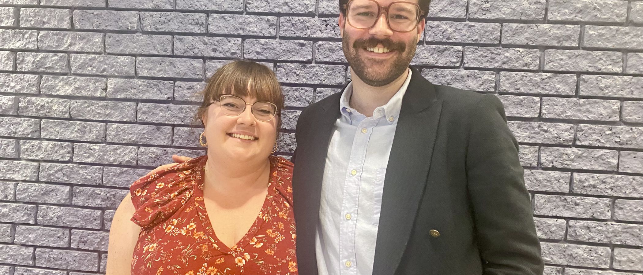 two grad students stand together