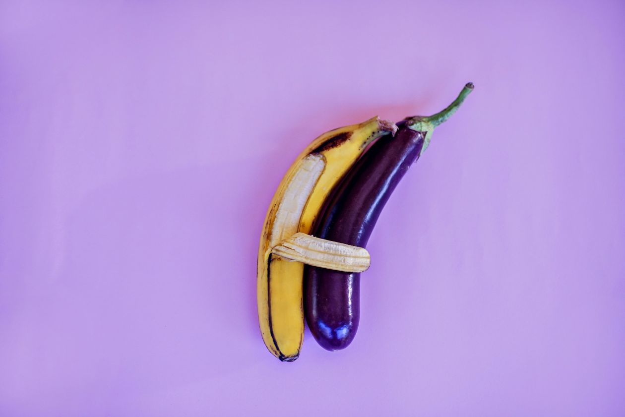 a banana taped to an eggplant