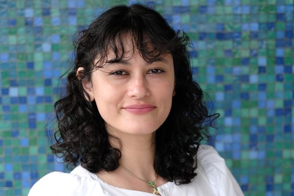 photo of jade standing in front of a blue background