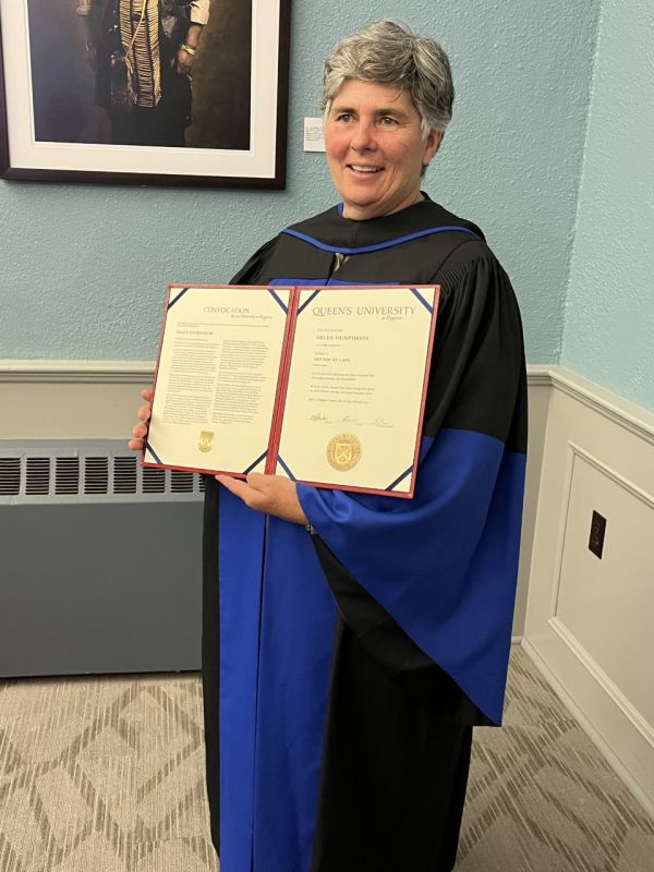 photo of Helen holding her doctorate 