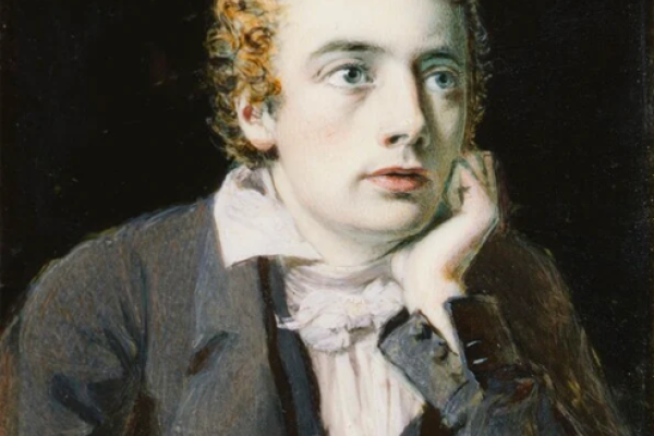 Man sitting at a desk resting head on palm of hand