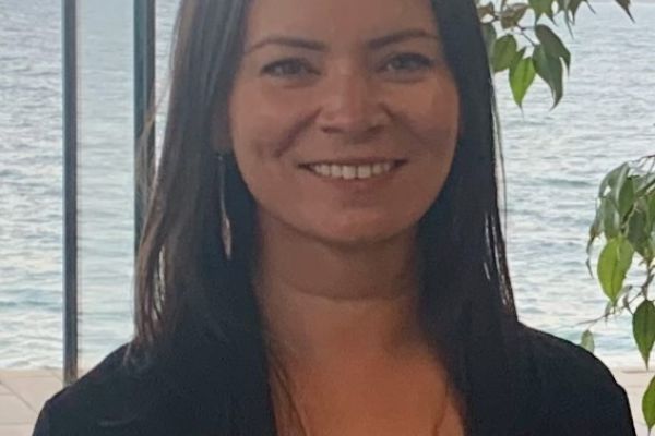 Photo of Tina posing with Lake Ontario in the background