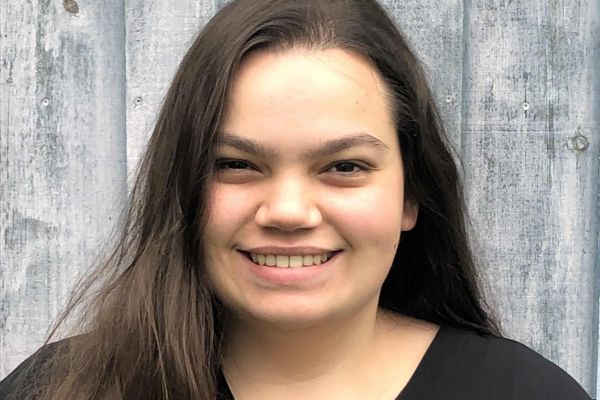 student standing in front of wall