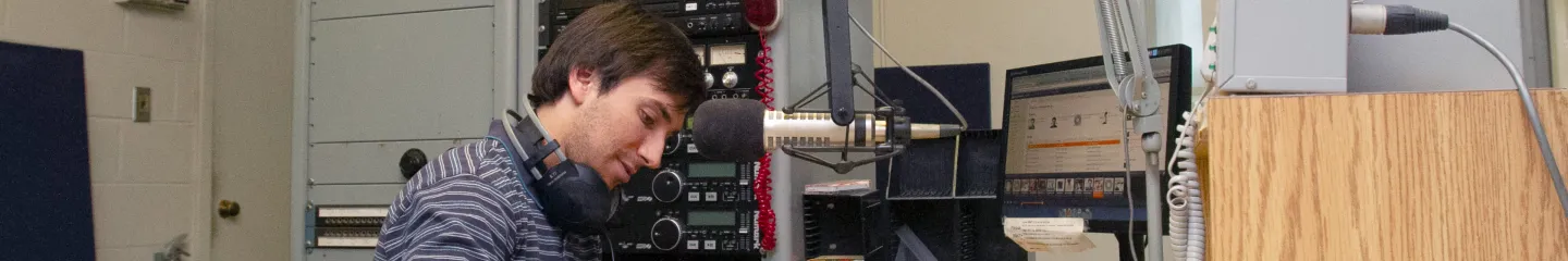 Photo of a person working at CFRC, Queen's campus radio station