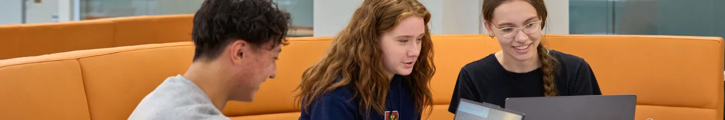 Queen's students using a computer.