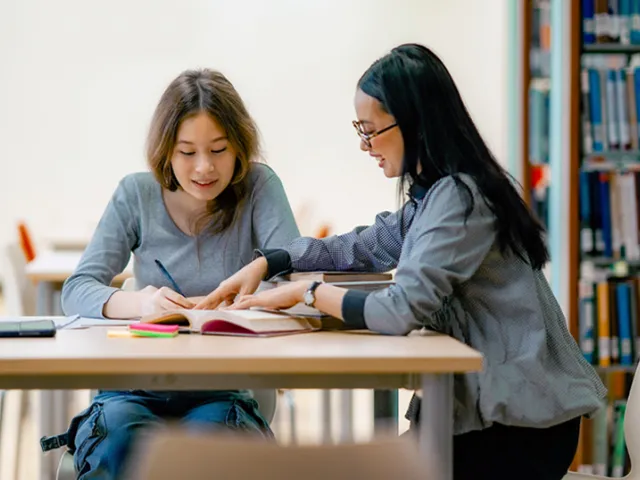 Photo of two students are studying together