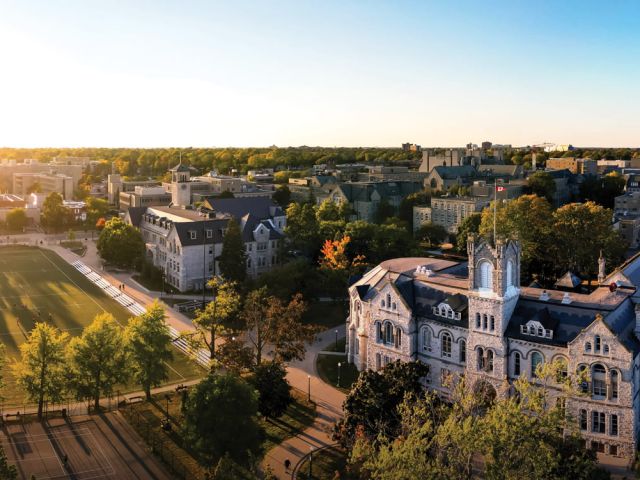 A photo overlooking Queen's University campus at sunset
